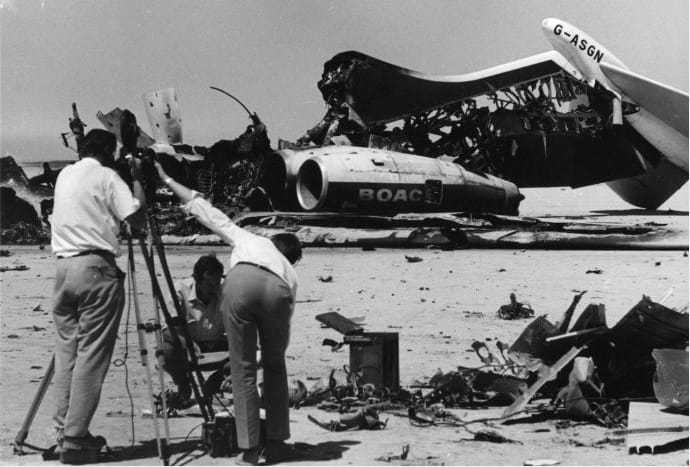 On This Day: 9th September 1970 : Palestinian Guerrillas Hijack a BOAC British Airliner from India bound for London and forced it to land in the Jordanian Dessert. This was the 4th hijacking plot that week by the group calling themselves the Popular Front for the Liberation of Palestine who demanded the release of 3 Arab prisoners held in West Germany. The BOAC Plane joined a Swissair DC8 and a Transworld Airlines Boeing 707 at the airstrip. 
Image: Journalists film the wreckage of exploded passenger planes at Dawson's Field, Zarqa, Jordan.  (Peter Davis/Getty Images)